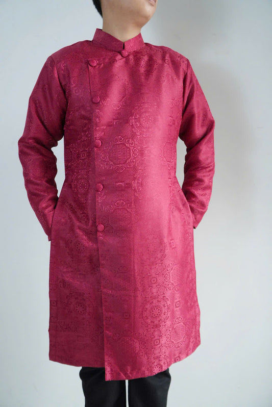 Red traditional outfit with intricate patterns on a plain background