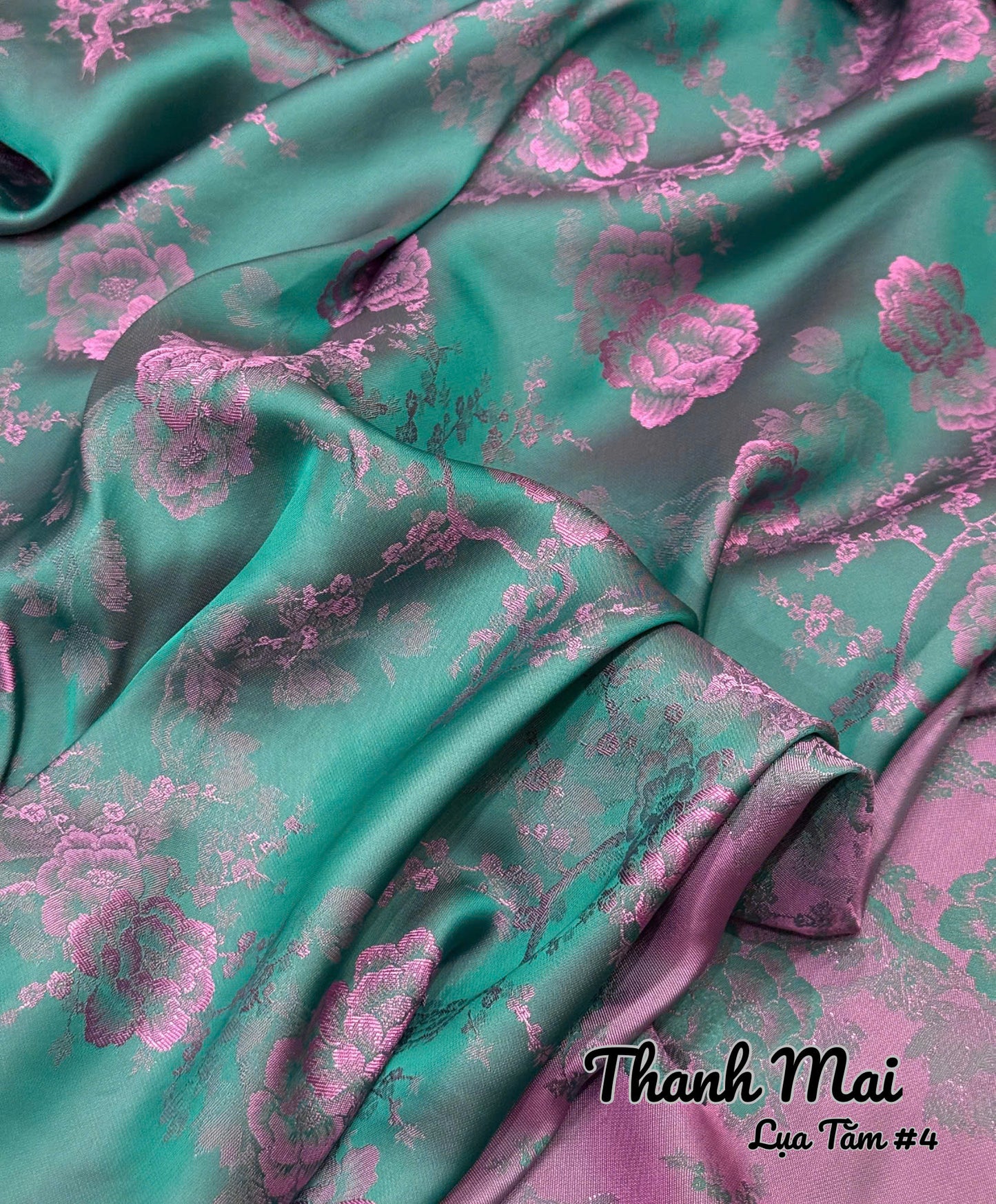 Teal fabric with pink floral pattern, brand 'Thanh Mai' visible