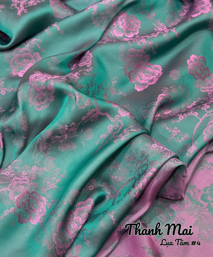 Teal fabric with pink floral pattern, brand 'Thanh Mai' visible